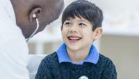 A boy speaking with a doctor