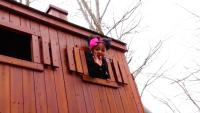 image of jenna skeete waving from a treehouse