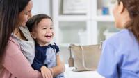 doctor with toddler and mom in office