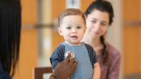 toddler being examined by a pediatrician
