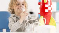 kid with cystic fibrosis playing with toy