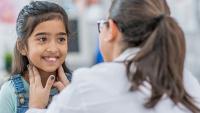 Young girl being examined by a doctor.
