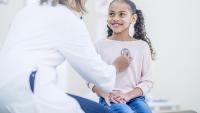pediatrician examining girl with stethoscope