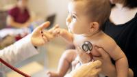pediatrician examining a baby with stethoscope