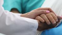 doctor holding hand of her patient