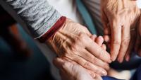 Doctor holding senior patient's hands