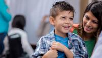 Young boy and parent speak with doctor