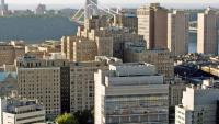An aerial shot of the CUIMC campus with the Hudson river and the George Washington bridge in the background