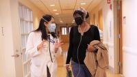Columbia Transplant clinician walks with lung transplant patient; patient is using supplemental oxygen.