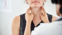 Woman having her lymph nodes checked during exam with doctor.