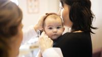 baby getting ear exam with mom