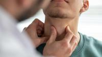 doctor examining patient throat
