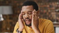Black male writer with a migraine.