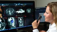 Radiologist reviews scans of torso during imaging test.