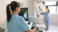 tech viewing patient preparing for a mammogram