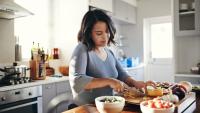 woman in kitchen cutting fruit
