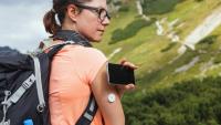 hiker in the mountains check her blood glucose level