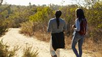 2 women on a hike on a desert trail