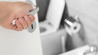 Person opening door to a bathroom