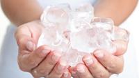 hands holding ice cubes