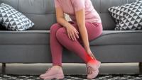 woman grabbing heel in pain with plantar fasciitis