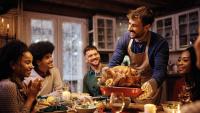 man bringing thanksgiving turkey to table