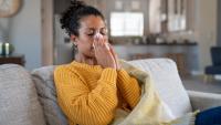 woman suffering from winter allergies indoors