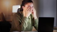 woman with eye strain at a laptop