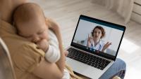 woman at laptop with infant