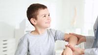 Doctor checking little boy's arm.