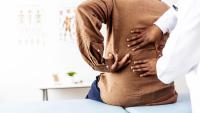 patient with back pain at the doctor