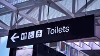 sign for bathrooms in airport