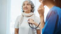 older woman being examined with a stethoscope