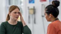 Woman meets her doctor to discuss her recent headaches.