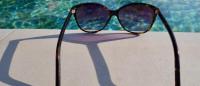 sunglasses at the edge of a pool