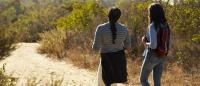 2 women on a hike on a desert trail
