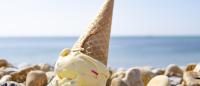 melting ice cream cone on rock beach
