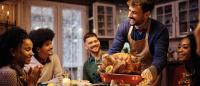 man bringing thanksgiving turkey to table