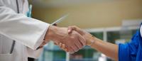 doctor shaking hands with patient