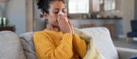 woman suffering from winter allergies indoors