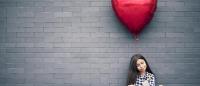 sad teengirl with red heart balloon