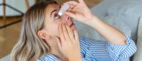 woman putting in eyedrops