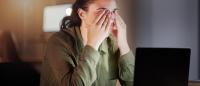 woman with eye strain at a laptop