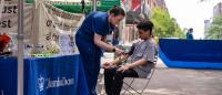 Columbia provider takes the blood pressure reading of young boy at the local Farmers Market.