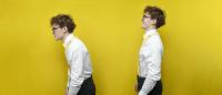 Man slouches while his twin stands with good posture.
