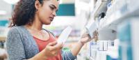 woman looking at medications in a pharmacy