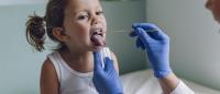 little girl getting a strep culture