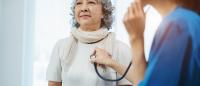 older woman being examined with a stethoscope