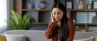 Woman experiencing ear pain.
