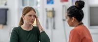 Woman meets her doctor to discuss her recent headaches.